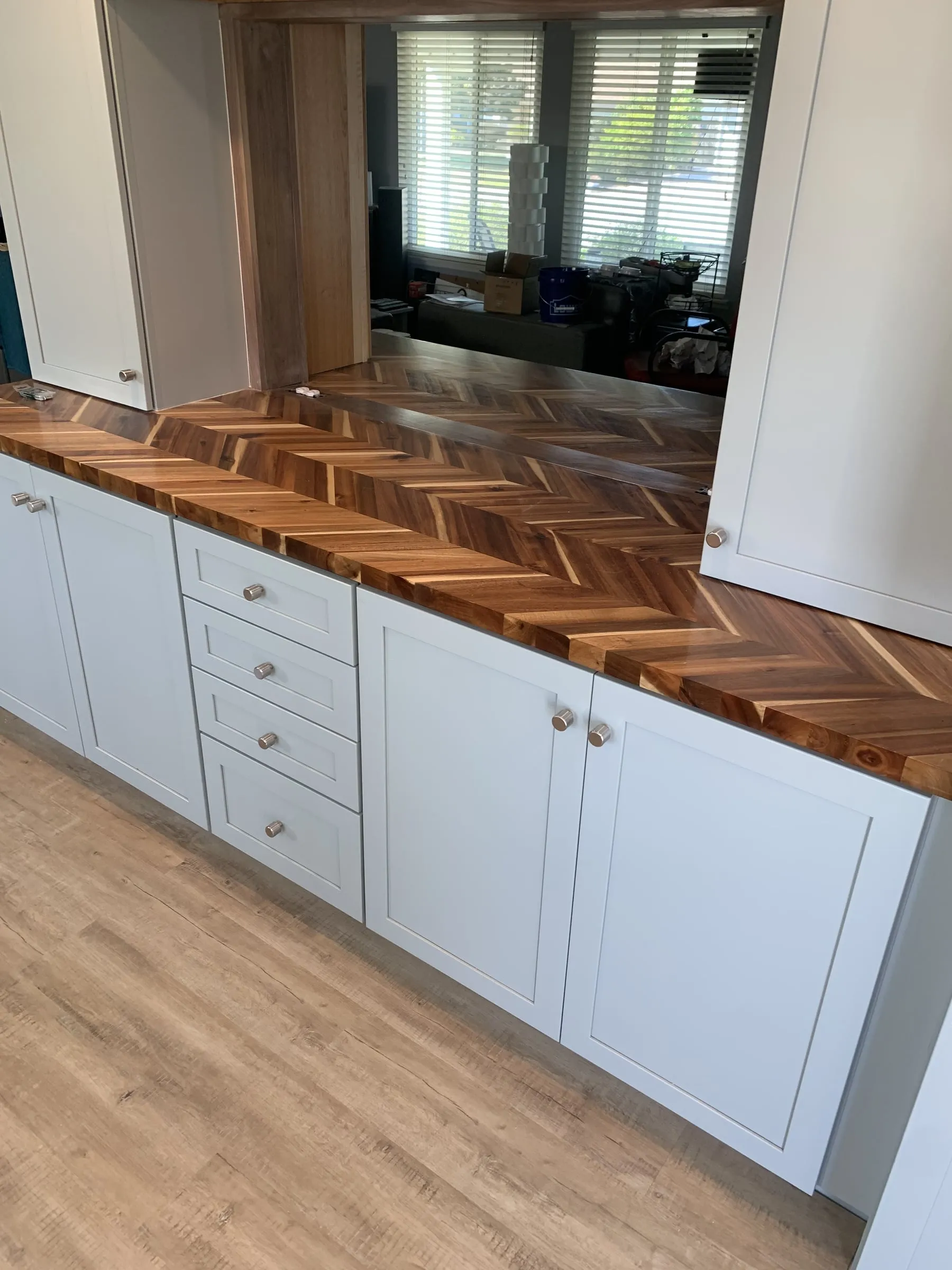 Galley kitchen, chevron wood counters: Chevron pattern wood counter