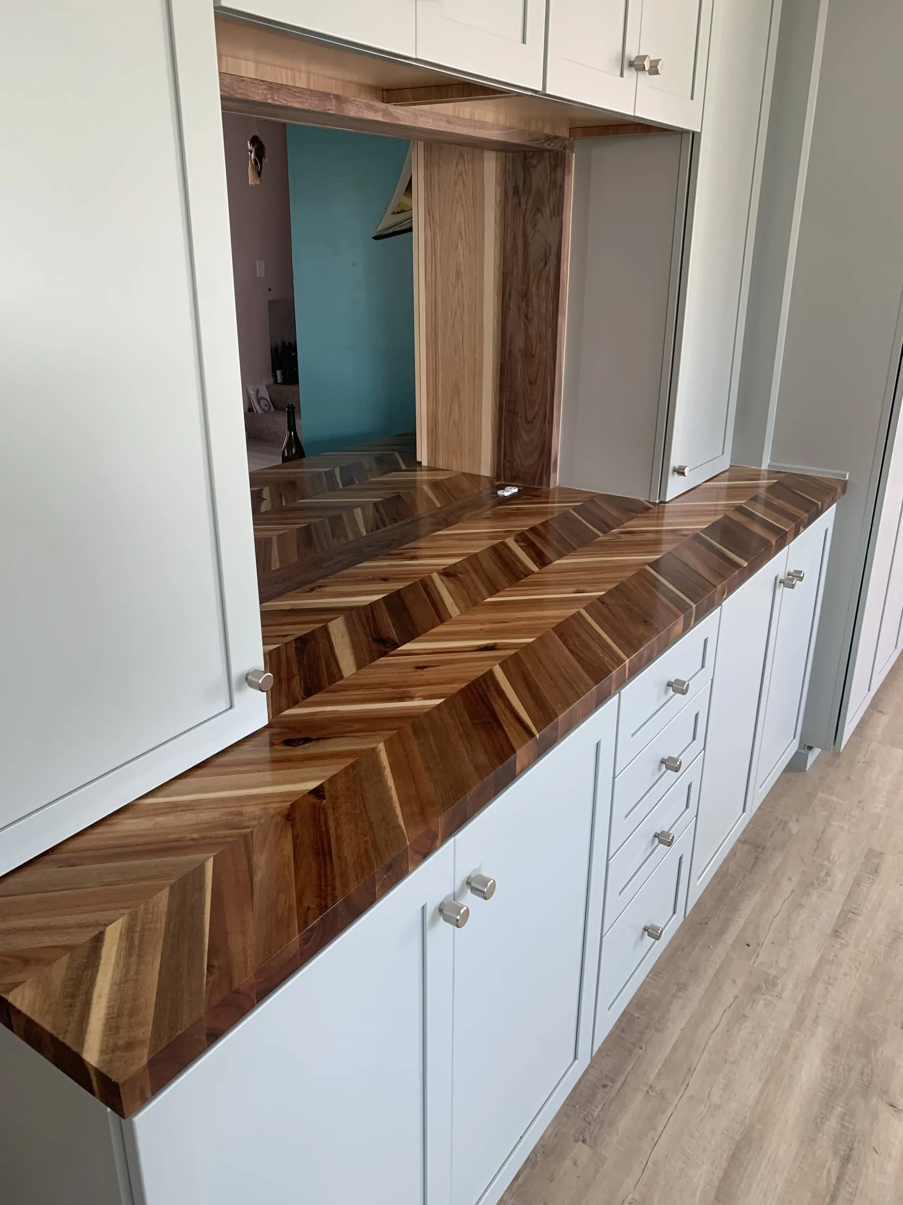 Galley kitchen, chevron wood counters: Counter and pass through