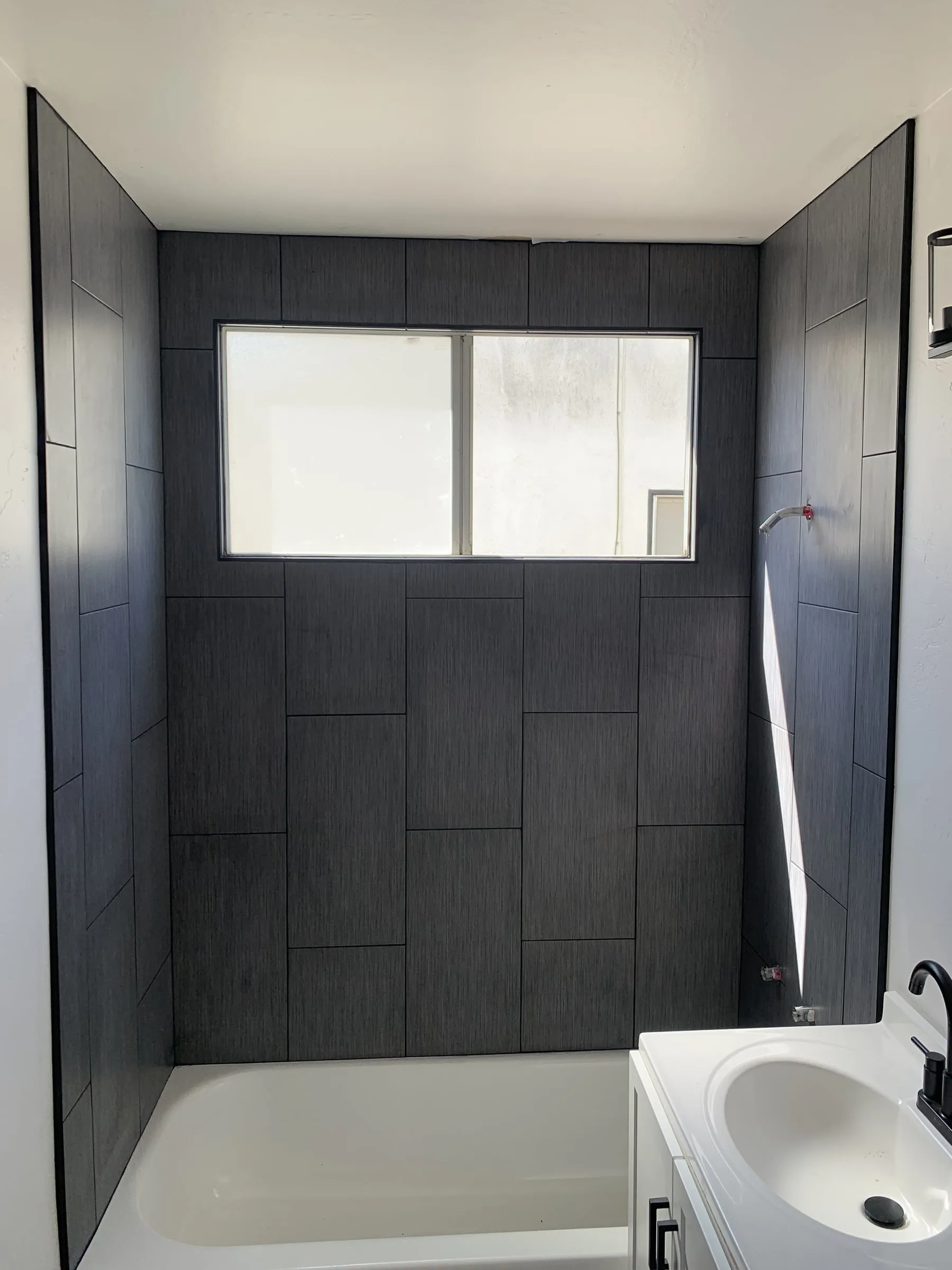 Charcoal tile tub surround: Finished tub surround