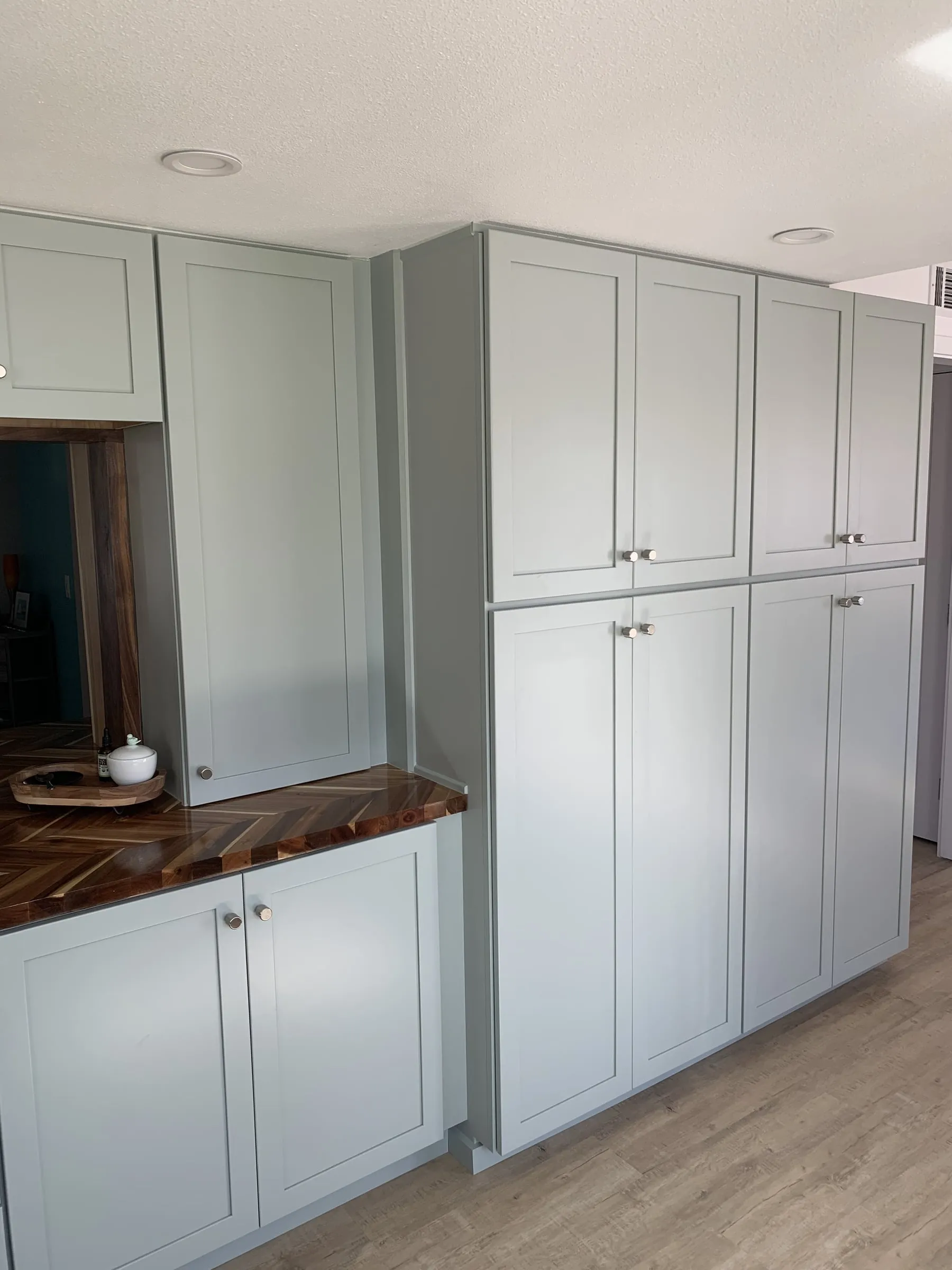 Galley kitchen, chevron wood counters: Pantry wall and counter