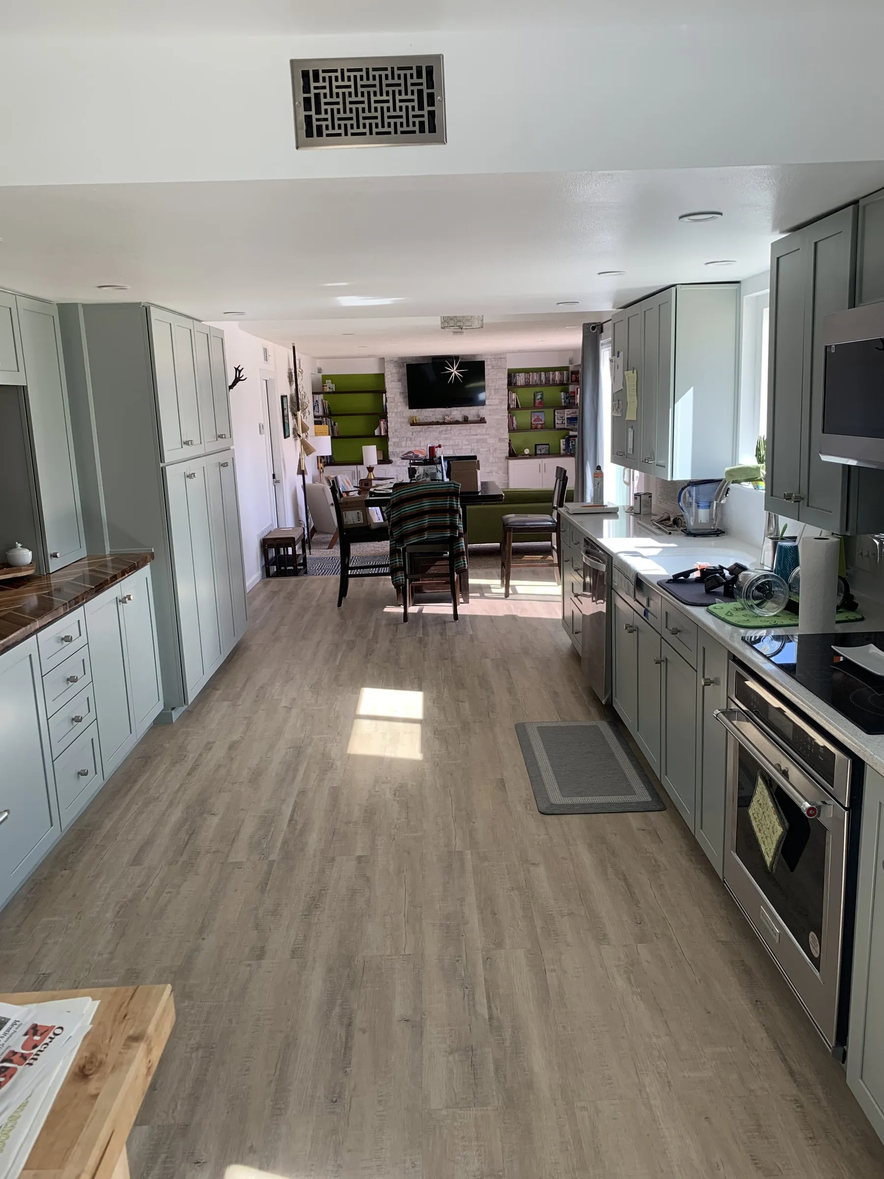 Galley kitchen, chevron wood counters: Full length of the kitchen