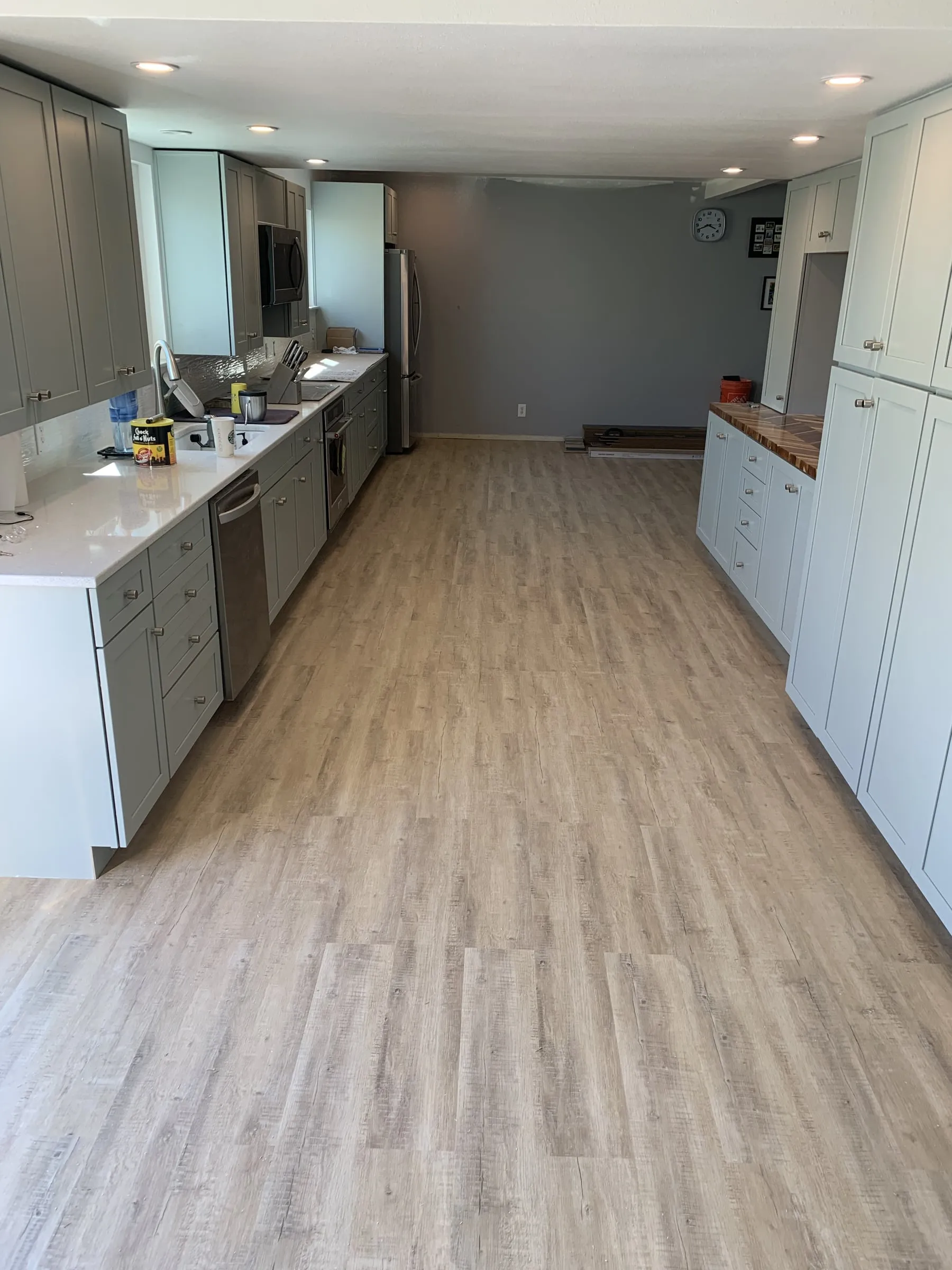 Galley kitchen, chevron wood counters: Laminate flooring throughout